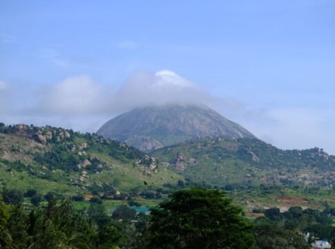 Stunning landscape of Nandi Hills in Karnataka, India, featuring a cloud-capped peak surrounded by lush greenery. Stunning landscape of Nandi Hills in Karnataka, India, featuring a cloud-capped peak surrounded by lush greenery.