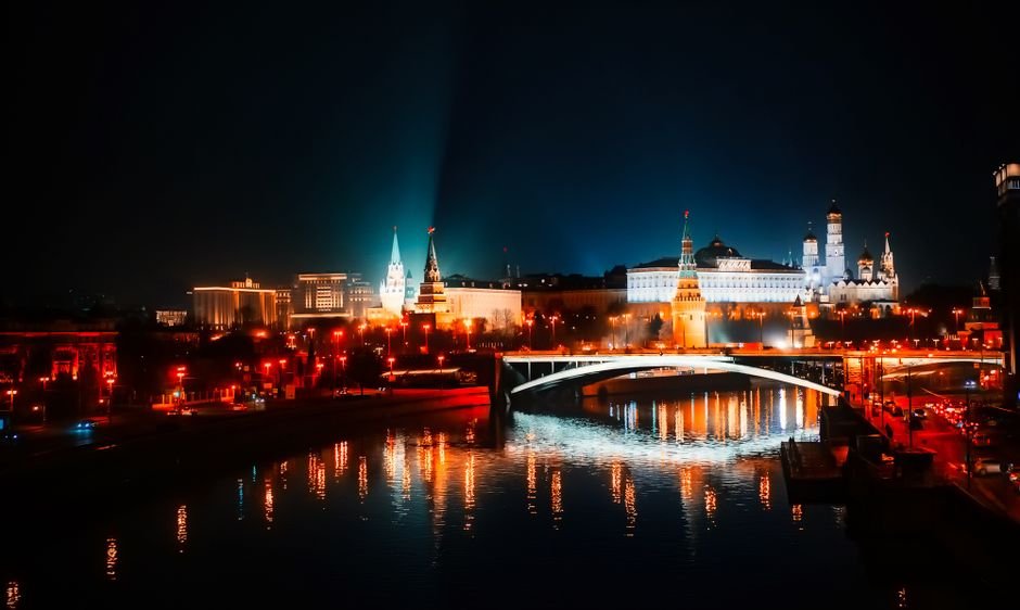 CIA Director Warned Russia Against NATO Aggression During Moscow Visit Stunning night view of Moscow's illuminated skyline with reflections on the river.