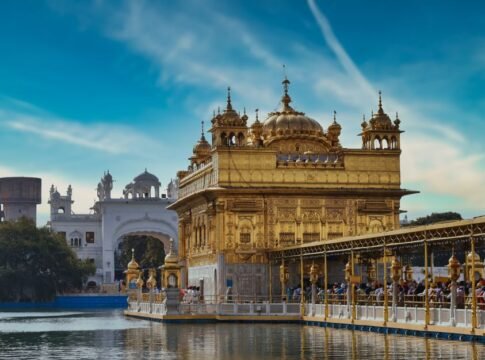 Stunning view of the Golden Temple in Amritsar, India, gleaming under the bright sky. Stunning view of the Golden Temple in Amritsar, India, gleaming under the bright sky.