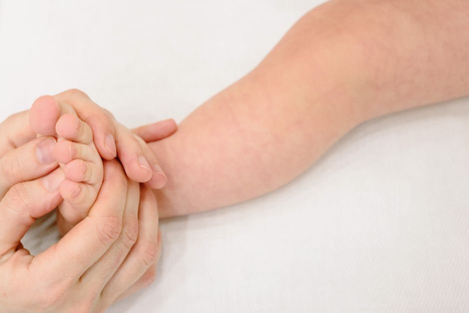 Pennsylvania Confirms Two Measles Deaths Amidst Widespread Outbreak Tender infant foot massage providing soothing comfort and care.