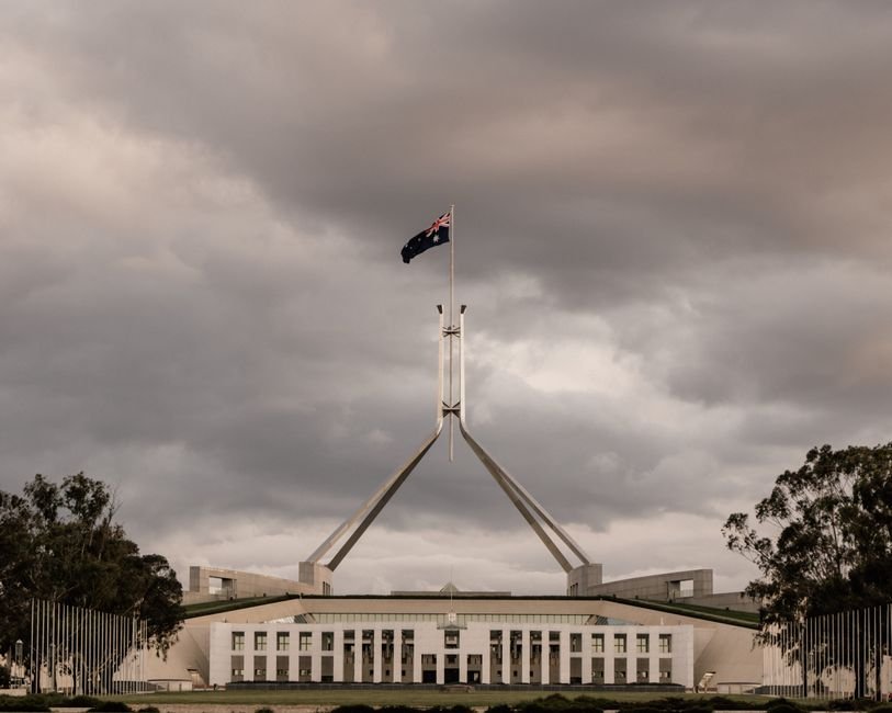 Australian Minister Julian Hill States Racists Are a Minority The Parliament House of Australia in Canberra with a dramatic cloudy backdrop.