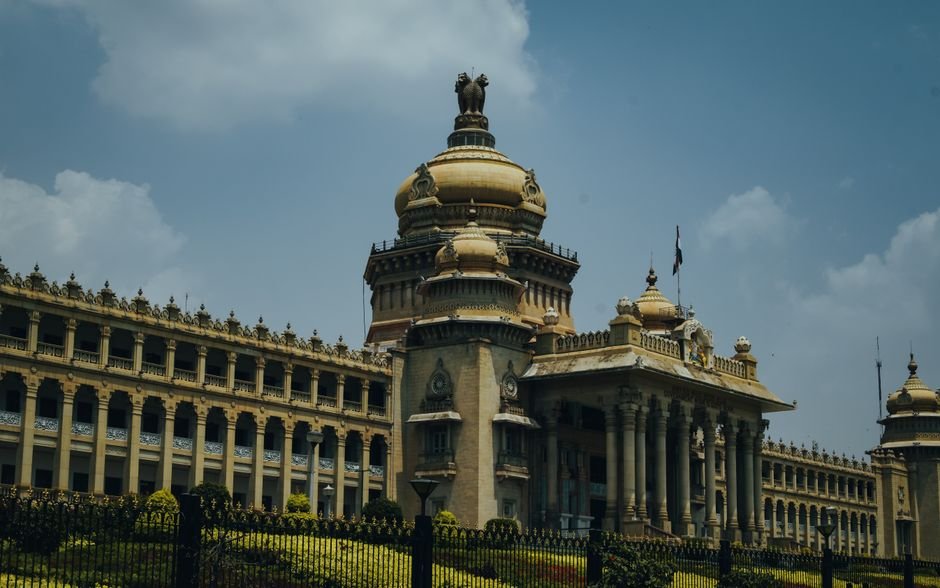 Karnataka Government to Provide Subsidised Blood to APL Patients The majestic Vidhana Soudha in Bengaluru captured under a vibrant blue sky.