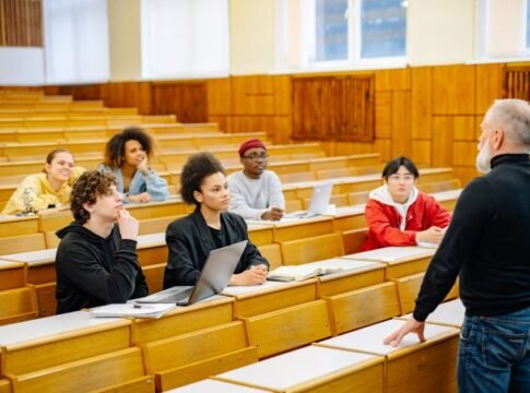 University students engaging in a diverse classroom setting with a lecturer.