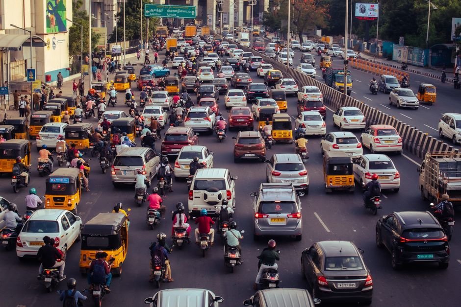 Tamil Nadu Transport Officials Slap Rs 25 Lakh Fine on Omni Buses in Hosur Checks A crowded city street filled with cars, motorcycles, and buses during daytime rush hour.