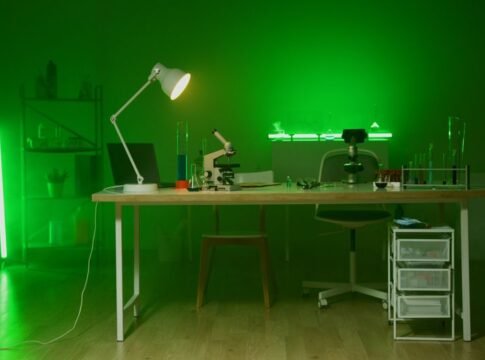 A modern lab setup with a microscope and green lighting, focused on research and technology. A modern lab setup with a microscope and green lighting, focused on research and technology.