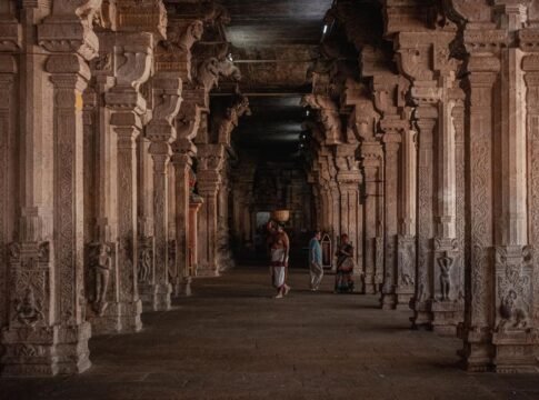 A stunning view of an intricately designed temple corridor in Tiruchirappalli, showcasing traditional Dravidian architecture.