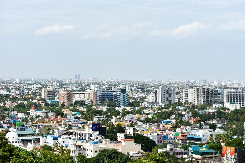 Starbucks to Establish First India Global Capability Center in Chennai, Creating 800 Jobs Aerial view of colorful high-rise buildings in Chennai, India, under a clear sky.