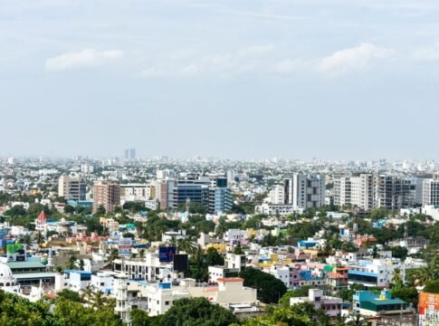 Aerial view of colorful high-rise buildings in Chennai, India, under a clear sky.
