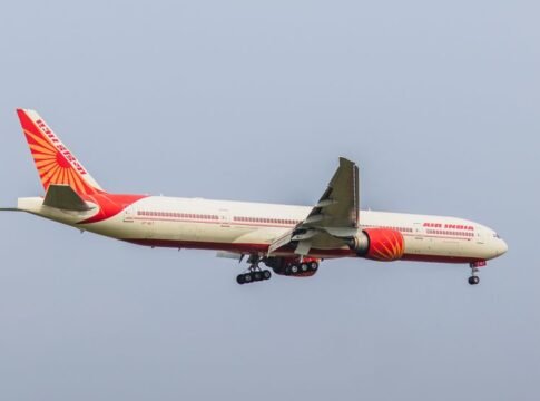 Air India Boeing 777 captured in clear sky during flight approach. Perfect aviation stock image.