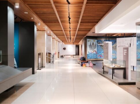 Bright museum hallway with exhibits and empty walkways, showcasing modern design. Bright museum hallway with exhibits and empty walkways, showcasing modern design.