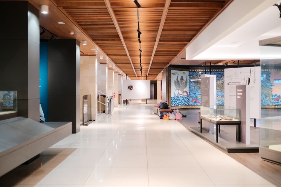 Jenjum Gadi Exhibition ‘Ngok Dolu’ Explores Memory and Landscape in New Delhi Bright museum hallway with exhibits and empty walkways, showcasing modern design.