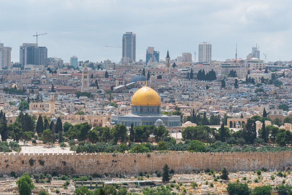 UK-Israel Relations Strain Over West Bank Settlement Dispute Captivating aerial view of the Dome of the Rock with Jerusalem's skyline in the background.