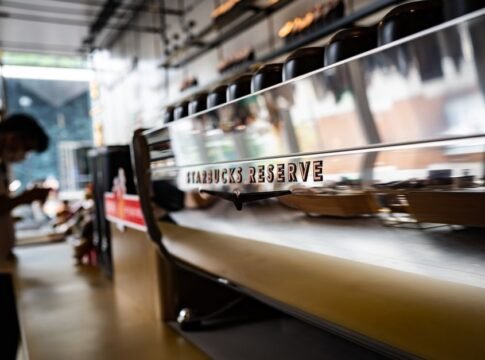 Contemporary Starbucks Reserve coffeeshop interior featuring a sleek espresso machine with a reflective surface. Contemporary Starbucks Reserve coffeeshop interior featuring a sleek espresso machine with a reflective surface.