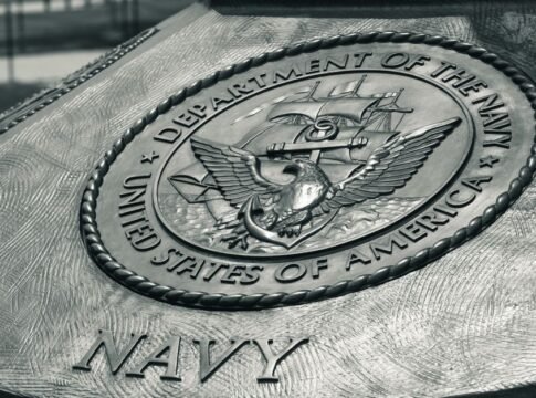 Detailed view of the United States Navy emblem on a monument in Washington D.C., showcasing naval heritage. Detailed view of the United States Navy emblem on a monument in Washington D.C., showcasing naval heritage.