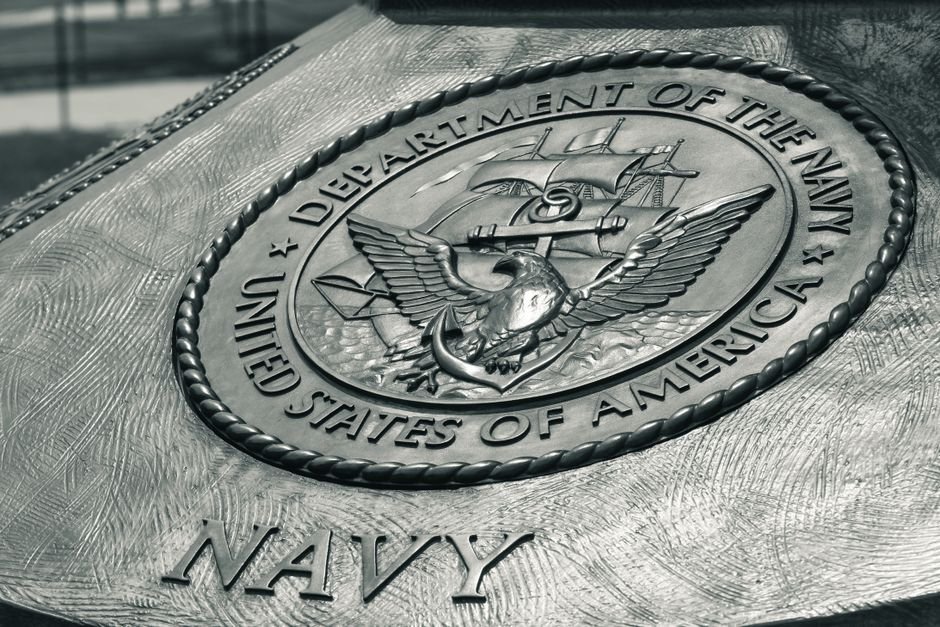 U.S. Navy Destroys Three Iranian Oil Tankers in Gulf Following Missile Strikes Detailed view of the United States Navy emblem on a monument in Washington D.C., showcasing naval heritage.