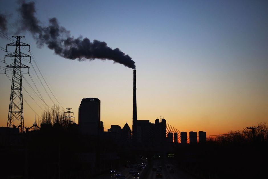 Delhi’s Monsoon Air Quality Worst in Seven Years: CREA Analysis Dramatic sunset silhouette of an industrial smokestack with pollution in the urban skyline.