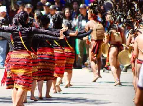 Energetic cultural dance parade showcasing traditional attire and festive spirit in the Philippines.