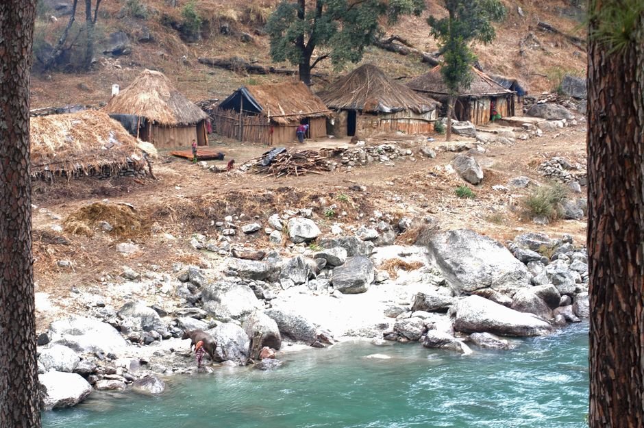 Explore the rustic lifestyle along an Indian riverbank with traditional huts and a serene environment.