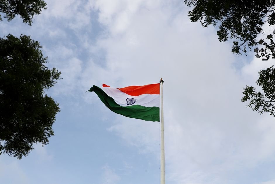 Jammu and Kashmir Congress to Raise Public Issues Despite NC Alliance: Karra Low angle shot of the Indian national flag on a flagpole with a clear blue sky.