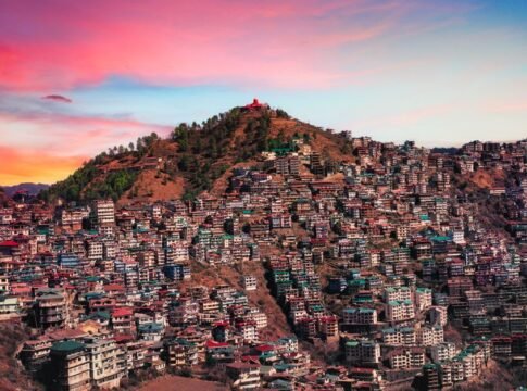 Majestic aerial view of Shimla, India with colorful buildings against a vibrant sunset sky. Majestic aerial view of Shimla, India with colorful buildings against a vibrant sunset sky.