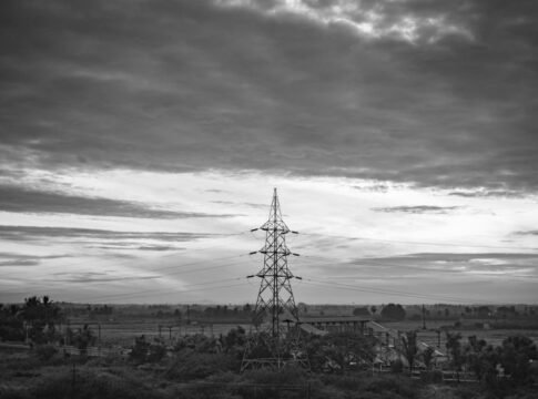 Monochrome rural landscape featuring transmission tower and clouds in Nanguneri, India. Monochrome rural landscape featuring transmission tower and clouds in Nanguneri, India.
