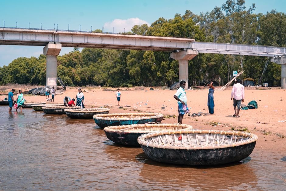 Tamil Nadu Moves Supreme Court Against Karnataka Over Cauvery Water Release People enjoy a serene day by coracle boats on a sandy riverbank in Mysuru, India.