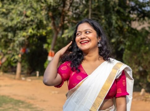 Smiling Indian woman in a traditional saree enjoying a sunny day outdoors in Bhubaneswar, India. Smiling Indian woman in a traditional saree enjoying a sunny day outdoors in Bhubaneswar, India.