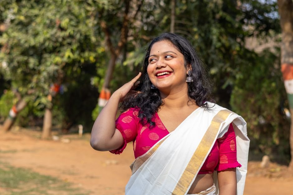 Himachal Pradesh: Two Siblings Succumb to Snakebite in Mandi District Smiling Indian woman in a traditional saree enjoying a sunny day outdoors in Bhubaneswar, India.