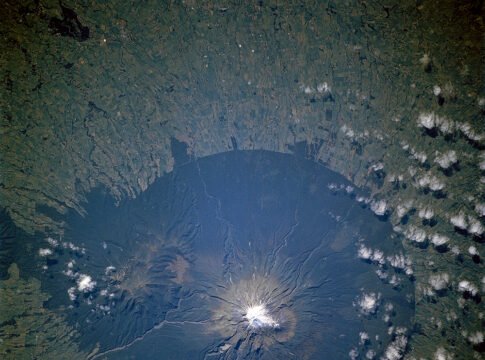 The lush forests of Egmont National Park, on New Zealand’s North Island, contrast with the pasturelands outside the circular park boundaries. The unique shape of the park results from its first prote… The lush forests of Egmont National Park, on New Zealand’s North Island, contrast with the pasturelands outside the circular park boundaries. The unique shape of the park results from its first prote…
