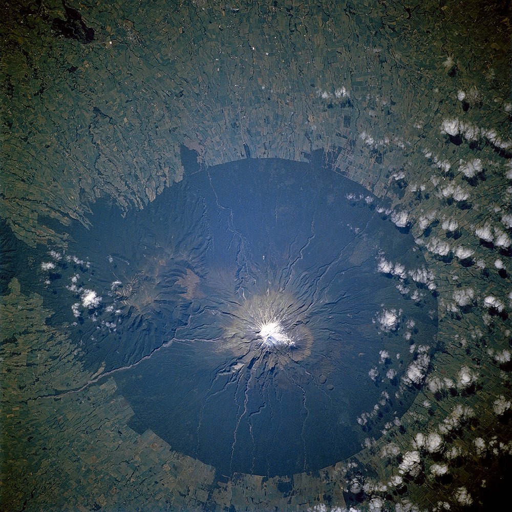 New Zealand’s Earth Sciences Organization Briefs UN on Disaster Resilience The lush forests of Egmont National Park, on New Zealand’s North Island, contrast with the pasturelands outside the circular park boundaries. The unique shape of the park results from its first prote…