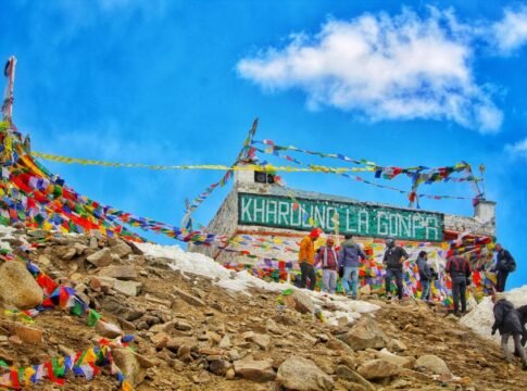 Vibrant scene of Khardung La Pass with people and prayer flags in Ladakh, India. Vibrant scene of Khardung La Pass with people and prayer flags in Ladakh, India.