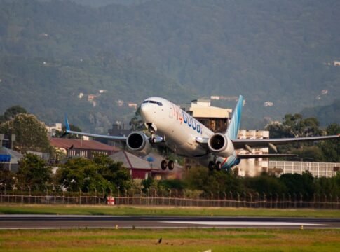 A Flydubai Boeing 737 passenger jet takes off from Batumi airport with mountains in the background. A Flydubai Boeing 737 passenger jet takes off from Batumi airport with mountains in the background.