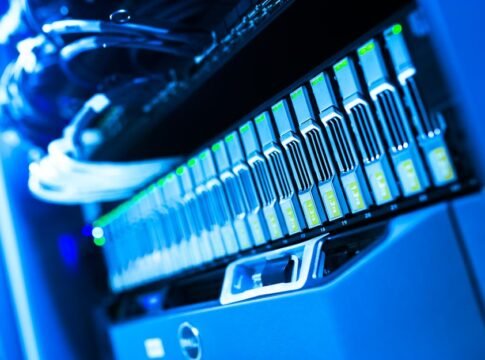 A detailed view of a blue lit computer server rack in a data center showcasing technology and hardware.