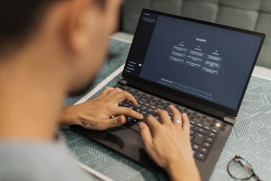 NVIDIA Expands RTX Spark Laptop Lineup with New Models and AI Capabilities A focused individual types on a laptop running AI software indoors.