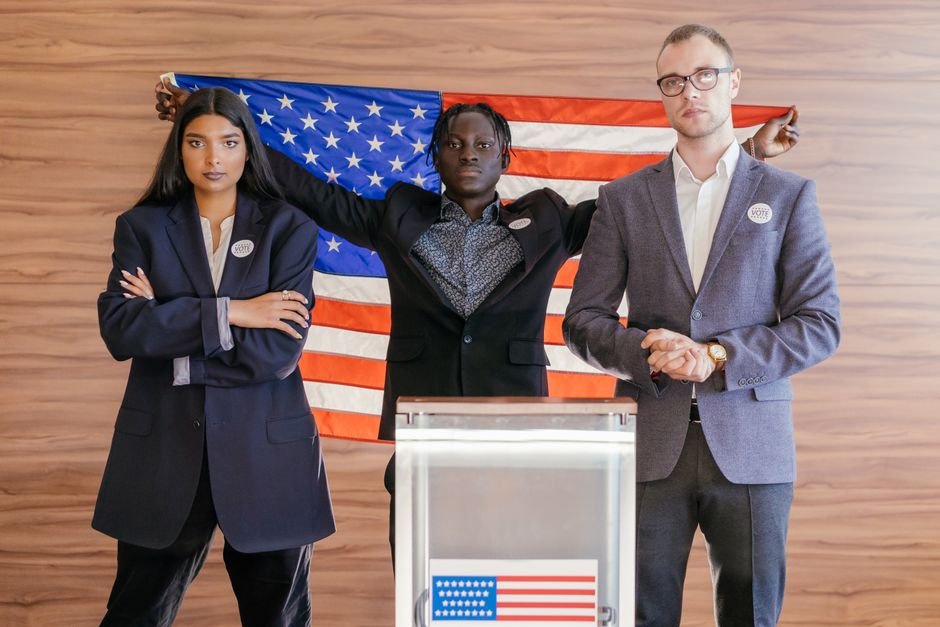 Record Campaign Spending Fuels US Midterm Elections Amid Shifting Republican Strategies A group of diverse individuals standing confidently in front of an American flag at an election podium.