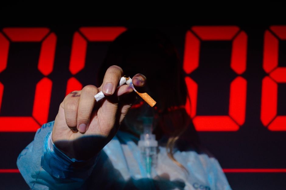 Himachal Pradesh Lauded Among Top States for Tobacco-Free Youth Campaign A hand holding a broken cigarette in front of a digital timer, highlighting the urgency of quitting smoking.
