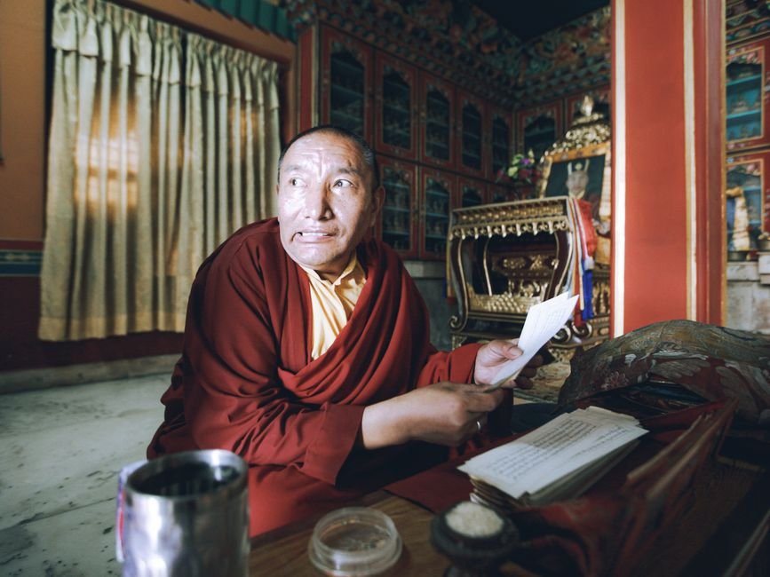Himachal Pradesh: Tibetan Leader Penpa Tsering States China Has No Authority Over Dalai Lama’s Succession A monk in traditional attire intently reads religious scriptures inside a decorated room.