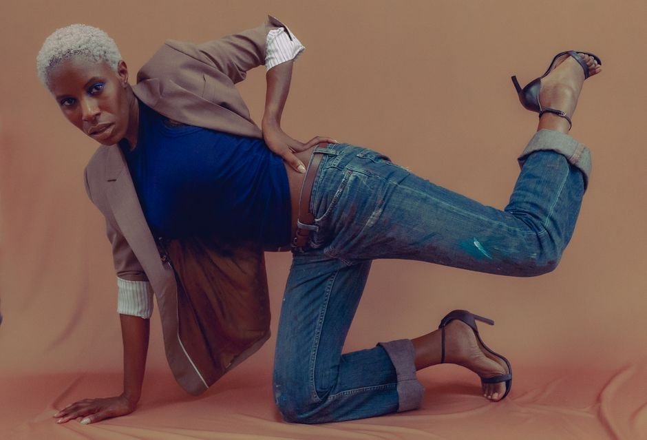 Cynthia Erivo Stars in ‘Nigerian Wicked’ Satire on ‘Saturday Night Live UK’ A stylish fashion model poses creatively in a suit jacket and jeans, emphasizing modern fashion trends.