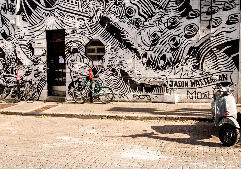 Veteran Producer Jason Simms Launches Fusebox Entertainment with Global Ambitions A vibrant black-and-white mural featuring bicycles and a scooter on an urban street.