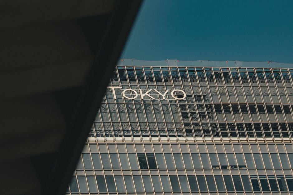Tokyo Film Festival Aims to Redefine Global Standing Ahead of 40th Anniversary A view of a modern building in Tokyo with reflective glass and urban architecture.