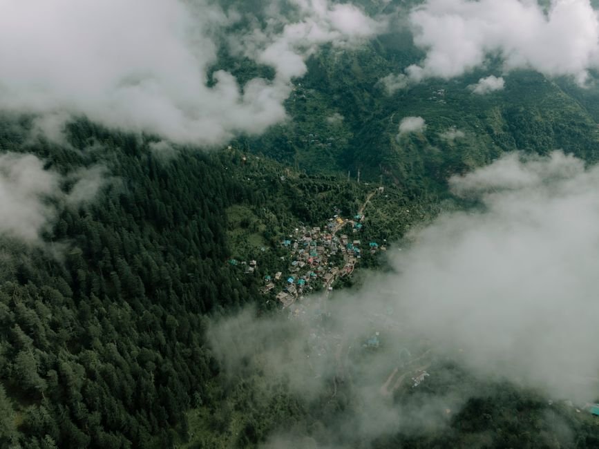 Kullu Dasehra Celebrations Unite Over 300 Deities in Himachal Pradesh’s ‘Dev Mahakumbh’ Aerial photograph showcasing a small village nestled among lush green mountains and clouds in Himachal Pradesh, India.