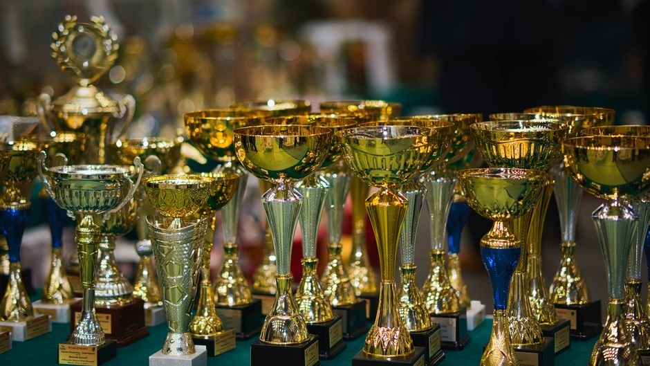 Punjab Gears Up for Asian Champions Trophy Hockey Tournament in Jalandhar Array of golden trophies on a table, reflecting victory and achievement.