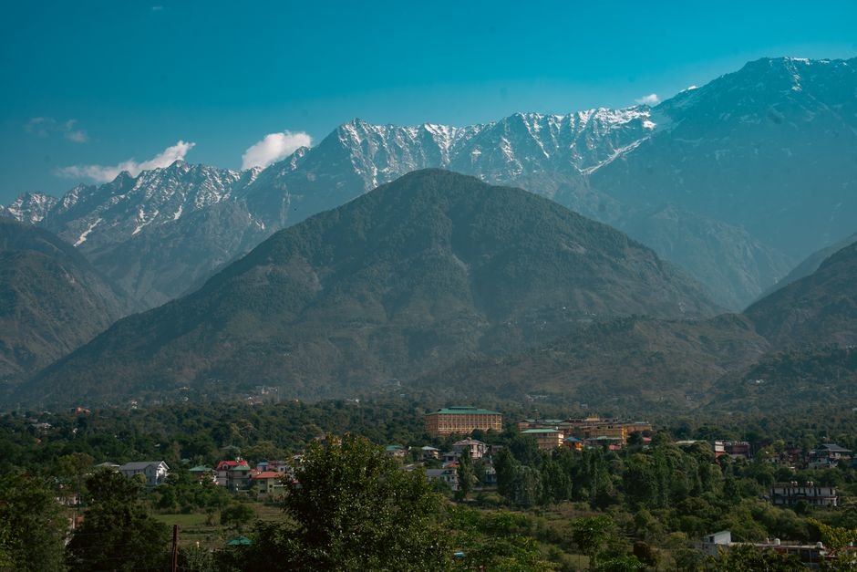 Himachal Pradesh University and Google Forge AI and Cybersecurity Collaboration Breathtaking mountain range with valley and cityscape under clear blue sky.