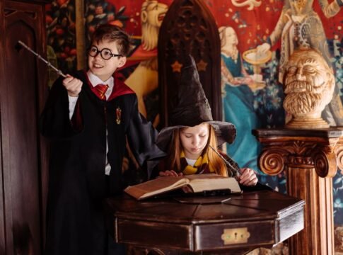 Children dressed as wizards engaged in magic-themed play, exploring spells in a fantasy setting.