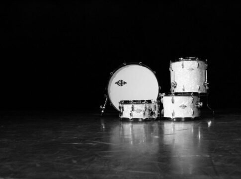 Classic black and white photo of a drum set in a dramatic, moody setting. Classic black and white photo of a drum set in a dramatic, moody setting.