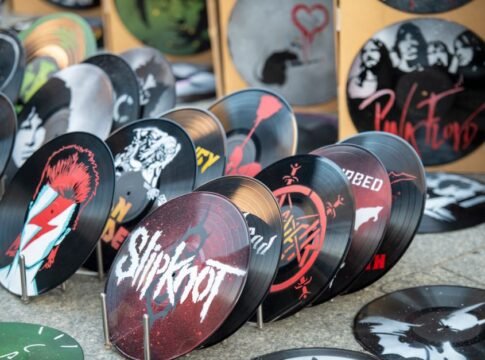 Collection of artistic vinyl records featuring iconic band designs on display at market. Collection of artistic vinyl records featuring iconic band designs on display at market.