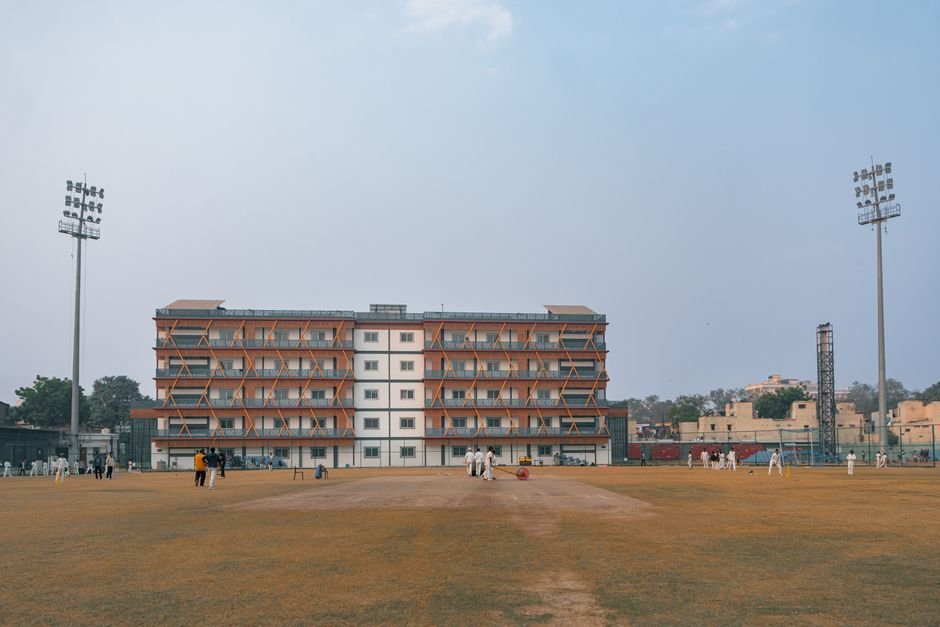 Delhi High Court Upholds Senior Citizens’ Right to Evict Ill-Treating Children Daytime cricket match on a large sports field in Delhi, India with players and floodlights.