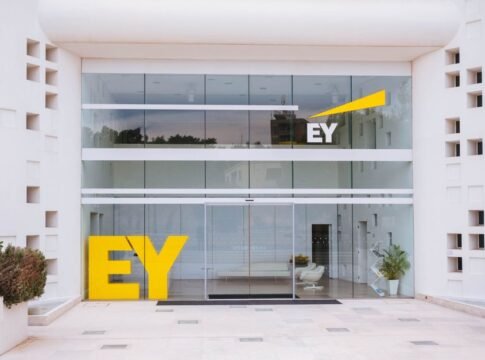Exterior view of a corporate building entrance with EY logo and minimalist design.