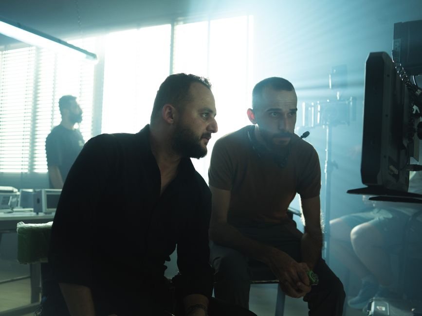 MIPCOM to Feature ‘Baywatch,’ ‘Einstein,’ and Bella Ramsey’s ‘Maya’ Among Top Scripted Titles Film crew members collaborating in a Baghdad studio with dramatic lighting.