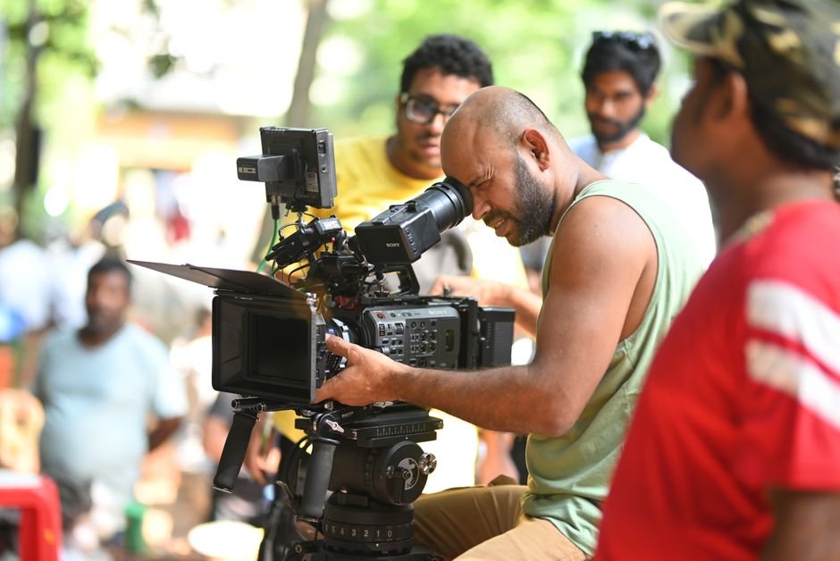Cappu Films Acquires International Rights for Fantasy Adventure ‘Starbright’ Ahead of Busan Market Filmmaker using a professional video camera on an outdoor set, surrounded by crew members.